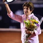 Maria Bueno shows off her plate and flowers
