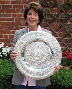 Maria Bueno shows off a newly-restored replica of the Wimbledon trophy