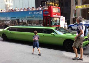 A green stretch limo in New York outside Niketown