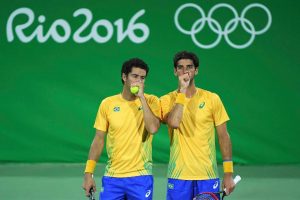 Thomaz Bellucci (BRA) of Brazil and Andre Sa (BRA) of Brazil [Photo: Reuters/Toby Melville]