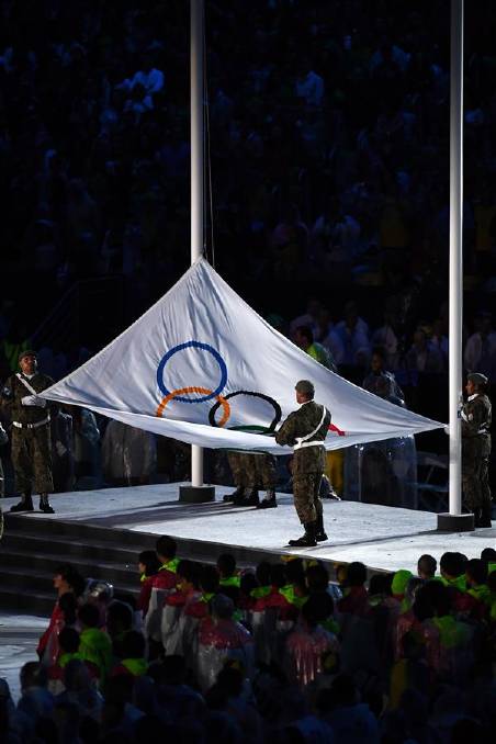 The Olympic Flag is taken down